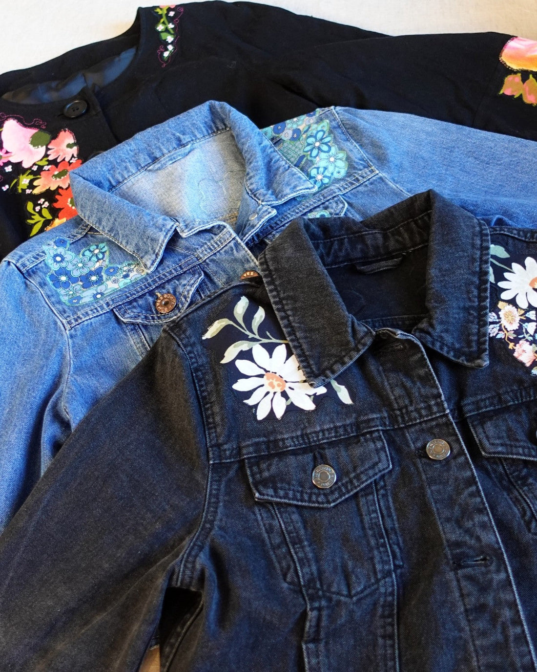 3 appliqued jackets by Hazy Made stacked on top of each other