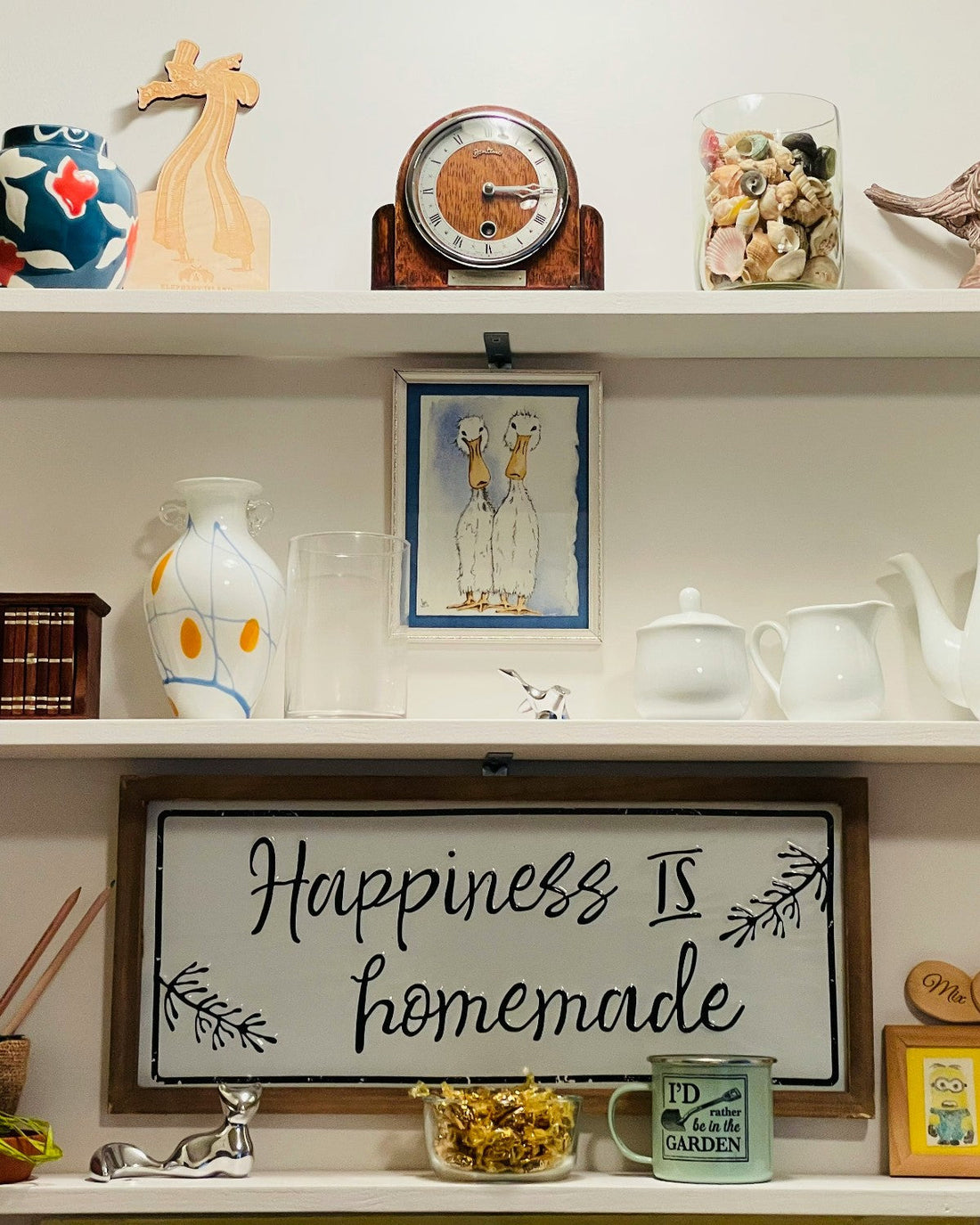 An eclectic selection of vintage homeware styled on white shelves
